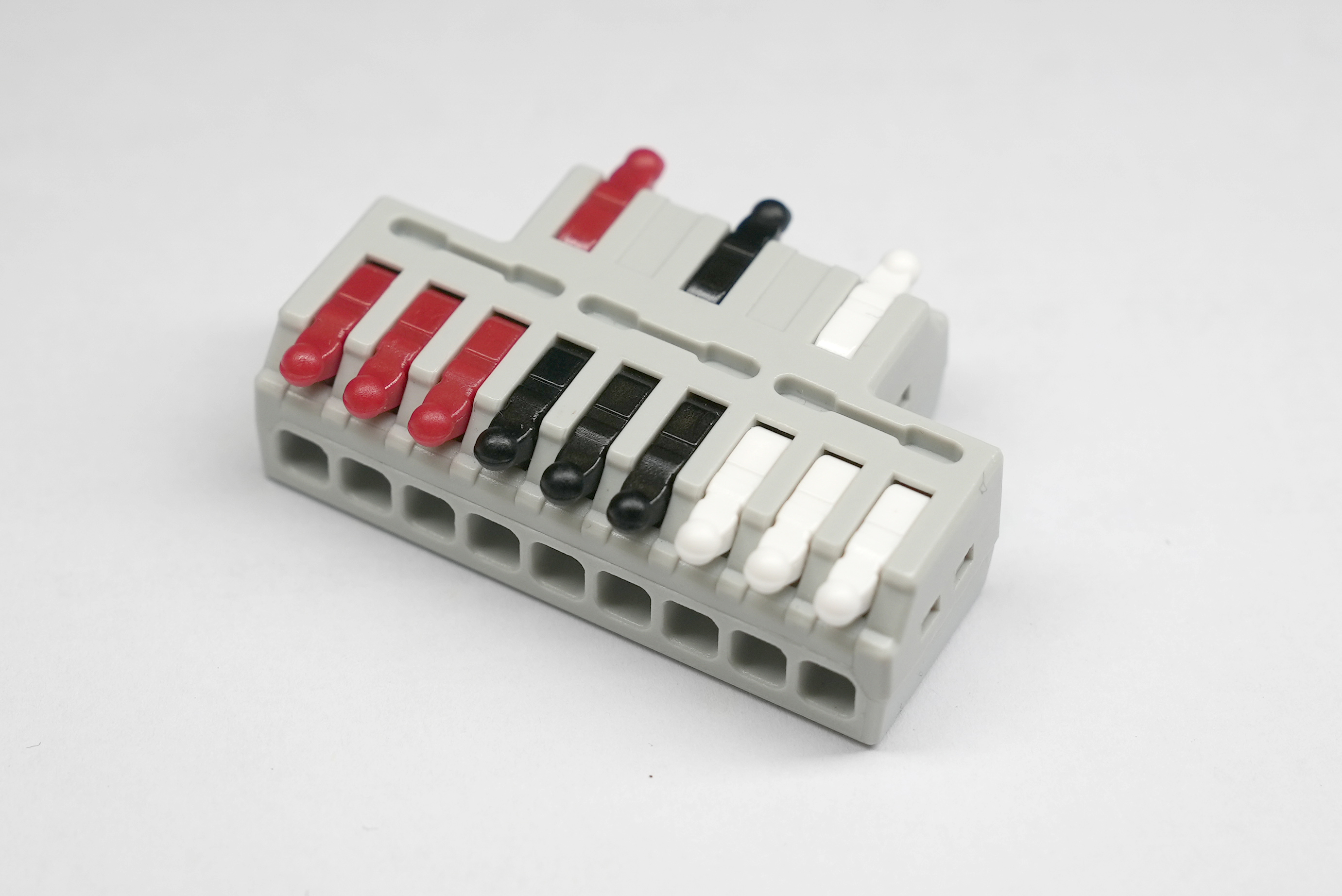 Original clear product photograph of the Tri-Power three-way bus connector with red,black and white terminal groups.